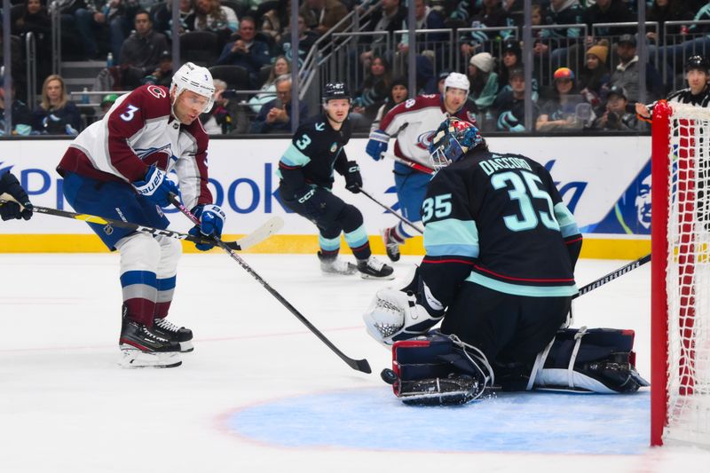 Nov 13, 2023; Seattle, Washington, USA; Seattle Kraken goaltender Joey Daccord (35) deflects a shot by Colorado Avalanche defenseman Jack Johnson (3) during the third period at Climate Pledge Arena. Mandatory Credit: Steven Bisig-USA TODAY Sports