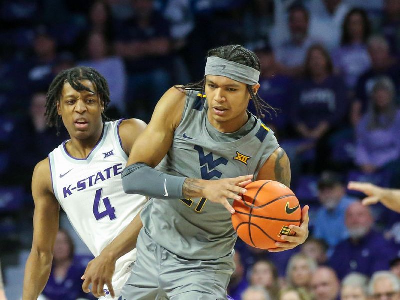 Feb 26, 2024; Manhattan, Kansas, USA; West Virginia Mountaineers guard RaeQuan Battle (21) is fouled by Kansas State Wildcats guard Dai Dai Ames (4) during the first half at Bramlage Coliseum. Mandatory Credit: Scott Sewell-USA TODAY Sports