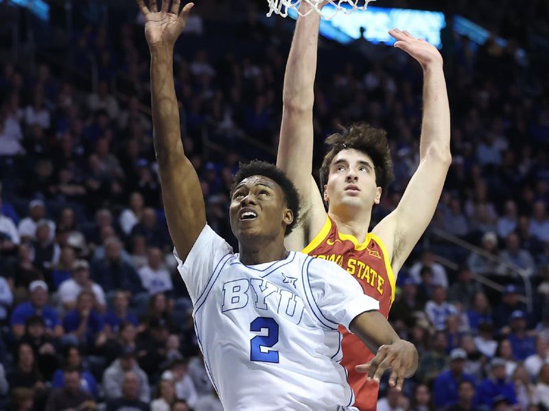 Jan 16, 2024; Provo, Utah, USA; Brigham Young Cougars guard Jaxson Robinson (2) lays the ball up against Iowa State Cyclones forward Milan Momcilovic (22) during the first half at Marriott Center. Mandatory Credit: Rob Gray-USA TODAY Sports