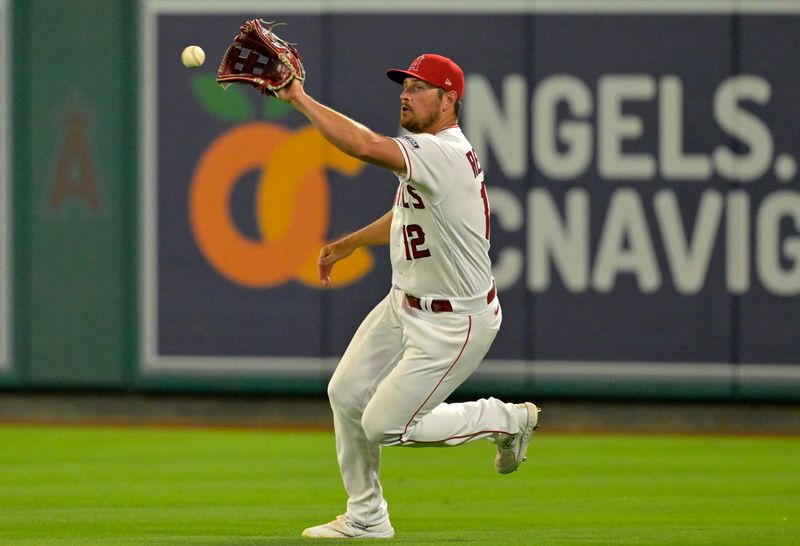 Aug 5, 2023; Anaheim, California, USA; Los Angeles Angels right fielder Hunter Renfroe (12) fields a RBI single by Seattle Mariners first baseman Ty France (23) in the eighth inning at Angel Stadium. Mandatory Credit: Jayne Kamin-Oncea-USA TODAY Sports