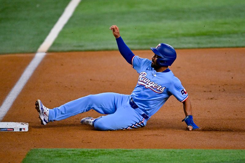 Aug 18, 2024; Arlington, Texas, USA; Texas Rangers second baseman Marcus Semien (2) slides into third base during the first inning at Globe Life Field. Mandatory Credit: Jerome Miron-USA TODAY Sports