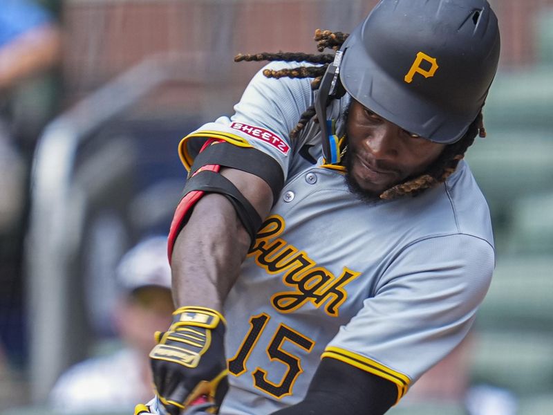 Jun 30, 2024; Cumberland, Georgia, USA; Pittsburgh Pirates shortstop Oneil Cruz (15) gets a base hit against the Atlanta Braves during the seventh inning at Truist Park. Mandatory Credit: Dale Zanine-USA TODAY Sports