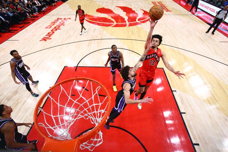 TORONTO, CANADA - MARCH 20: Jordan Nwora #13 of the Toronto Raptors drives to the basket during the game against the Sacramento Kings on March 20, 2024 at the Scotiabank Arena in Toronto, Ontario, Canada.  NOTE TO USER: User expressly acknowledges and agrees that, by downloading and or using this Photograph, user is consenting to the terms and conditions of the Getty Images License Agreement.  Mandatory Copyright Notice: Copyright 2024 NBAE (Photo by Vaughn Ridley/NBAE via Getty Images)