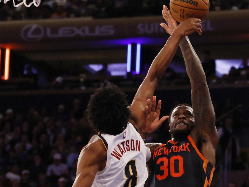 NEW YORK, NEW YORK - JANUARY 25: Julius Randle #30 of the New York Knicks goes to the basket as Peyton Watson #8 of the Denver Nuggets defends during the second half at Madison Square Garden on January 25, 2024 in New York City. NOTE TO USER: User expressly acknowledges and agrees that, by downloading and/or using this Photograph, user is consenting to the terms and conditions of the Getty Images License Agreement. (Photo by Sarah Stier/Getty Images)