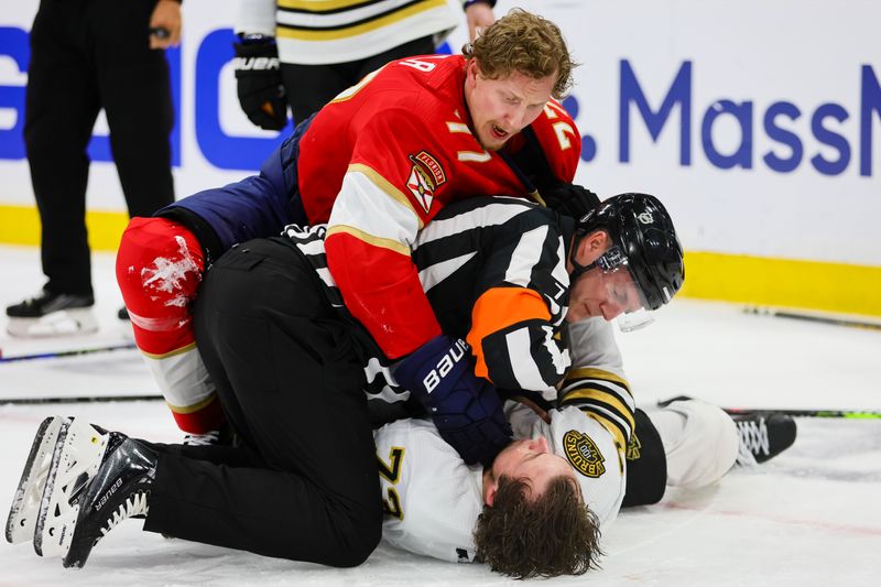 May 8, 2024; Sunrise, Florida, USA; Florida Panthers defenseman Niko Mikkola (77) and Boston Bruins defenseman Charlie McAvoy (73) fight during the third period in game two of the second round of the 2024 Stanley Cup Playoffs at Amerant Bank Arena. Mandatory Credit: Sam Navarro-USA TODAY Sports