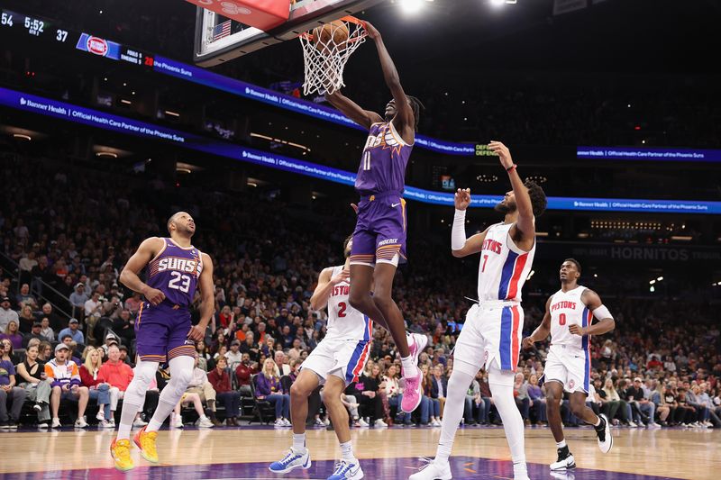 PHOENIX, ARIZONA - FEBRUARY 14:  Bol Bol #11 of the Phoenix Suns slam dunks the ball against the Detroit Pistons during the first half of the NBA game at Footprint Center on February 14, 2024 in Phoenix, Arizona. The Suns defeated the Pistons 116-100.  NOTE TO USER: User expressly acknowledges and agrees that, by downloading and or using this photograph, User is consenting to the terms and conditions of the Getty Images License Agreement.  (Photo by Christian Petersen/Getty Images)