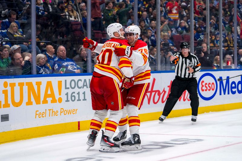 Oct 9, 2024; Vancouver, British Columbia, CAN; Calgary Flames forward Jonathan Huberdeau (10) and forward Martin Pospisil (76) celebrate Huberdeau’s goal against the Vancouver Canucks during the third period at Rogers Arena. Mandatory Credit: Bob Frid-Imagn Images