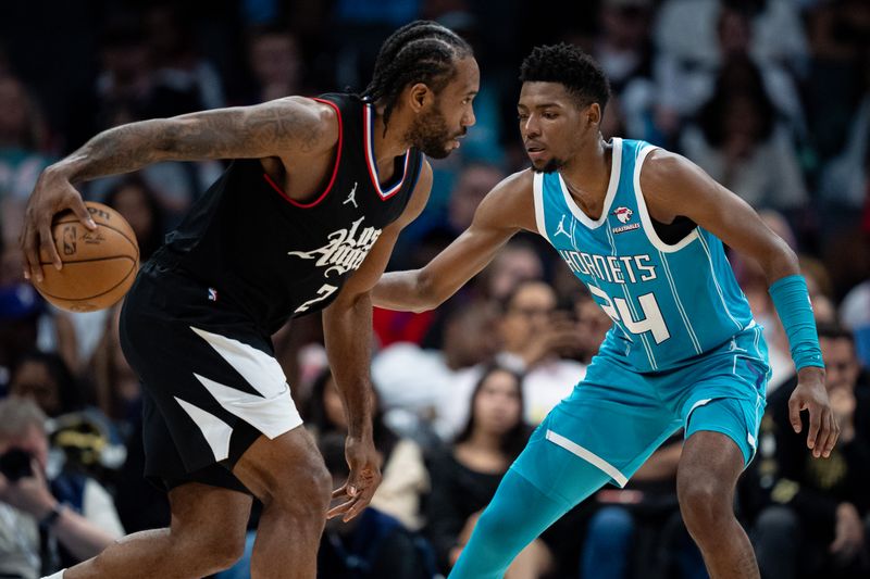 CHARLOTTE, NORTH CAROLINA - MARCH 31: Brandon Miller #24 of the Charlotte Hornets guards Kawhi Leonard #2 of the LA Clippers in the fourth quarter during their game at Spectrum Center on March 31, 2024 in Charlotte, North Carolina. NOTE TO USER: User expressly acknowledges and agrees that, by downloading and or using this photograph, User is consenting to the terms and conditions of the Getty Images License Agreement. (Photo by Jacob Kupferman/Getty Images)