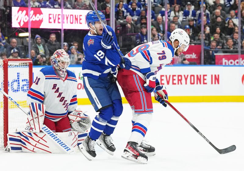 Dec 19, 2023; Toronto, Ontario, CAN; Toronto Maple Leafs center Calle Jarnkrok (19) gets hit with the puck batting with New York Rangers defenseman K'Andre Miller (79) in front of  goaltender Igor Shesterkin (31) during the third period at Scotiabank Arena. Mandatory Credit: Nick Turchiaro-USA TODAY Sports