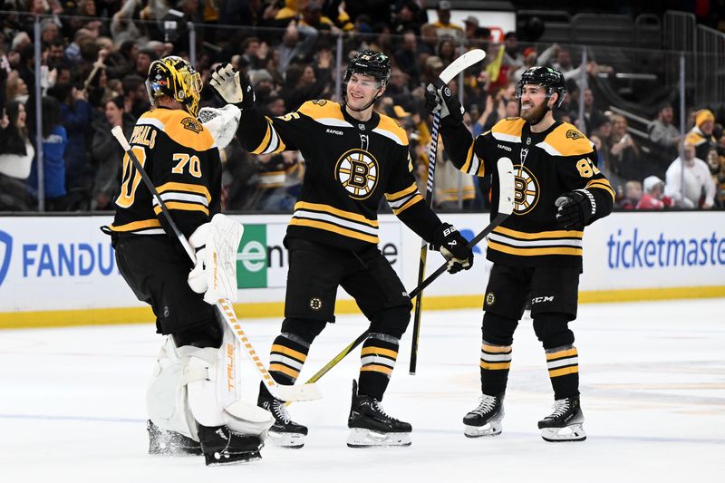 Dec 3, 2024; Boston, Massachusetts, USA; Boston Bruins defenseman Brandon Carlo (25) celebrates with goaltender Joonas Korpisalo (70) after a game against the Detroit Red Wings at the TD Garden. Mandatory Credit: Brian Fluharty-Imagn Images