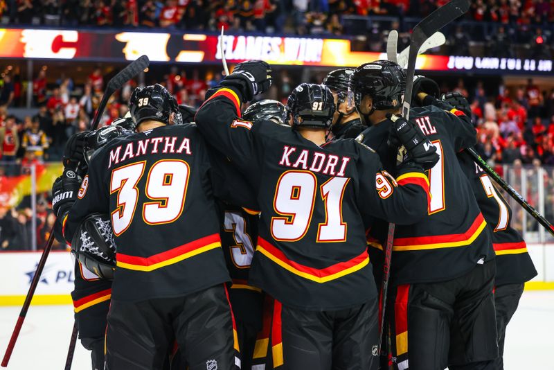 Oct 22, 2024; Calgary, Alberta, CAN; Calgary Flames players celebrates win over the Pittsburgh Penguins at Scotiabank Saddledome. Mandatory Credit: Sergei Belski-Imagn Images