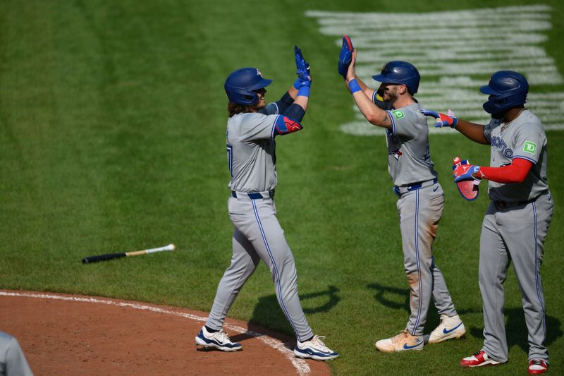 Jul 29, 2024; Baltimore, Maryland, USA; Toronto Blue Jays outfielder Addison Barger (47) celebrates with outfielder Addison Barger (47) and first baseman Vladimir Guerrero Jr. (27) after hitting a home run against the Baltimore Orioles during the fifth inning at Oriole Park at Camden Yards. Mandatory Credit: Reggie Hildred-USA TODAY Sports