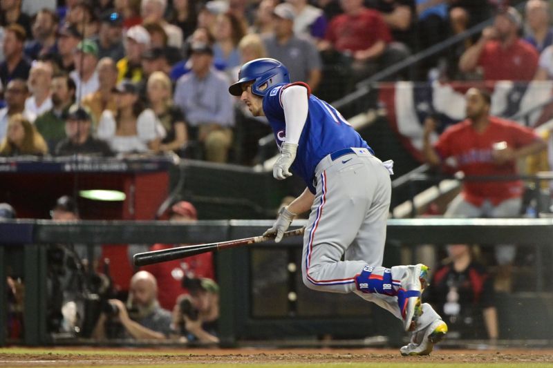 Nov 1, 2023; Phoenix, AZ, USA; Texas Rangers catcher Mitch Garver (18) hits a n RBI-singel in the seventh inning in game five of the 2023 World Series at Chase Field. Mandatory Credit: Matt Kartozian-USA TODAY Sports