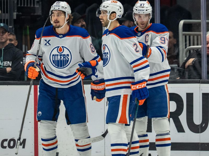 Oct 25, 2025; Seattle, Washington, USA; Edmonton Oilers, from left, forward David Tomasek (86), defenseman Evan Bouchard (2) and forward Connor McDavid (97) celebrate a goald during the second period against the Seattle Kraken at Climate Pledge Arena. Mandatory Credit: Stephen Brashear-Imagn Images
