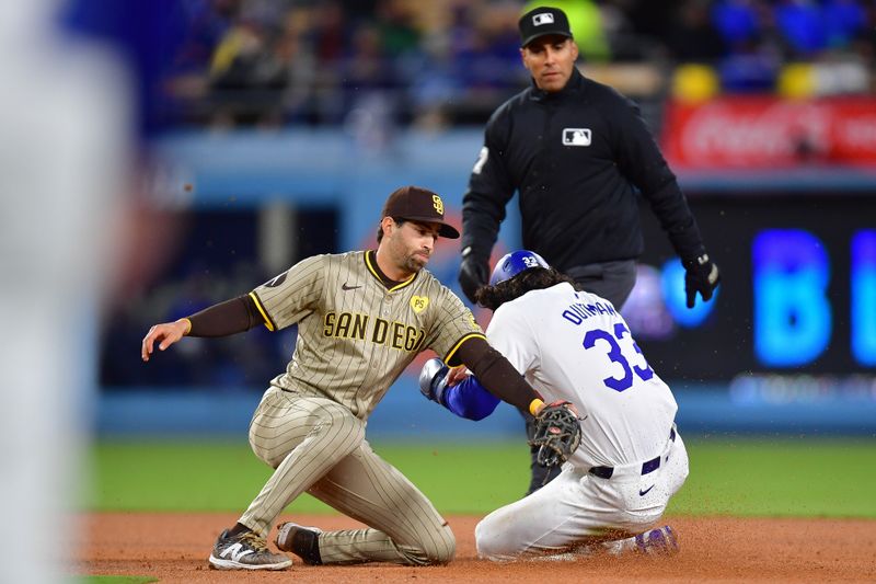 Apr 13, 2024; Los Angeles, California, USA; Los Angeles Dodgers center fielder James Outman (33) steals second against San Diego Padres second baseman Tyler Wade (14) during the fourth inning at Dodger Stadium. Mandatory Credit: Gary A. Vasquez-USA TODAY Sports