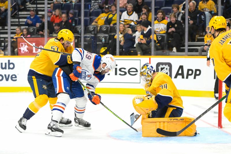 Oct 17, 2024; Nashville, Tennessee, USA;  Nashville Predators goaltender Juuse Saros (74) blocks the shot of Edmonton Oilers center Adam Henrique (19) during the second period at Bridgestone Arena. Mandatory Credit: Steve Roberts-Imagn Images