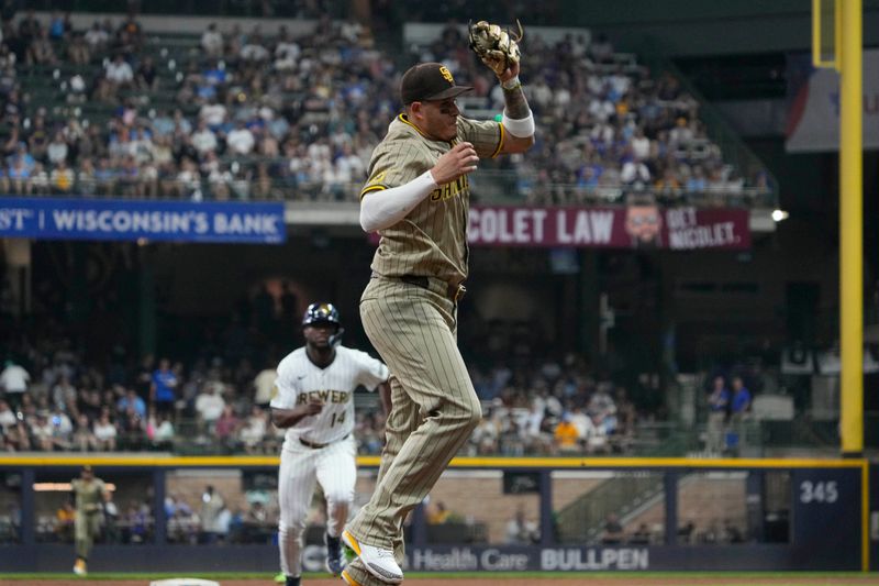 Jun 8, 2025; Milwaukee, Wisconsin, USA; San Diego Padres third base Manny Machado (13) fields the ball and gets the force out at third base against the Milwaukee Brewers in the seventh inning at American Family Field. Mandatory Credit: Michael McLoone-Imagn Images