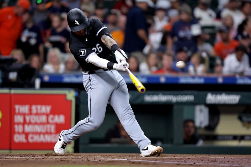 Aug 16, 2024; Houston, Texas, USA; Chicago White Sox catcher Korey Lee (26) hits a double to center field against the Houston Astros during the second inning at Minute Maid Park. Mandatory Credit: Erik Williams-USA TODAY Sports