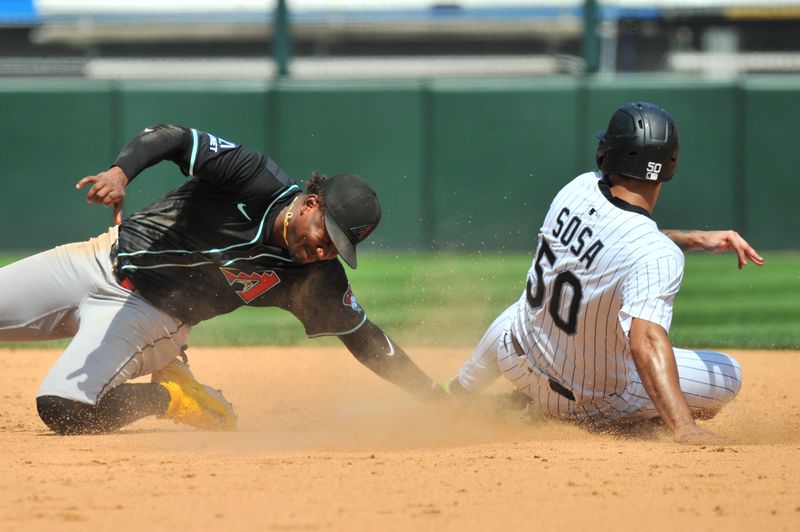 Jun 25, 2025; Chicago, Illinois, USA; Arizona Diamondbacks shortstop Geraldo Perdomo (2) tags out Chicago White Sox second baseman Lenyn Sosa (50) during the steal attempt during the sixth inning at Rate Field. Mandatory Credit: Patrick Gorski-Imagn Images