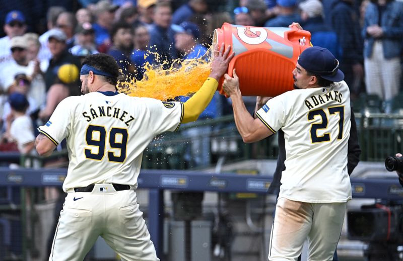 May 30, 2024; Milwaukee, Wisconsin, USA; Milwaukee Brewers shortstop Willy Adames (27) douses catcher Gary Sánchez (99) with Gatorade after winning the game against the Chicago Cubs at American Family Field. Mandatory Credit: Michael McLoone-USA TODAY Sports