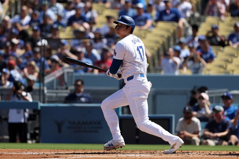 Sep 22, 2024; Los Angeles, California, USA;  Los Angeles Dodgers designated hitter Shohei Ohtani (17) hits a single during the first inning against the Colorado Rockies at Dodger Stadium. Mandatory Credit: Kiyoshi Mio-Imagn Images