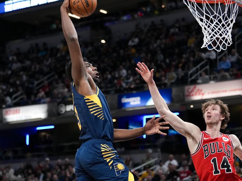 INDIANAPOLIS, INDIANA - MARCH 02: Thomas Bryant #3 of the Indiana Pacers dunks the ball while being guarded by Matas Buzelis #14 of the Chicago Bulls in the second quarter at Gainbridge Fieldhouse on March 02, 2025 in Indianapolis, Indiana. NOTE TO USER: User expressly acknowledges and agrees that, by downloading and or using this photograph, User is consenting to the terms and conditions of the Getty Images License Agreement. (Photo by Dylan Buell/Getty Images)