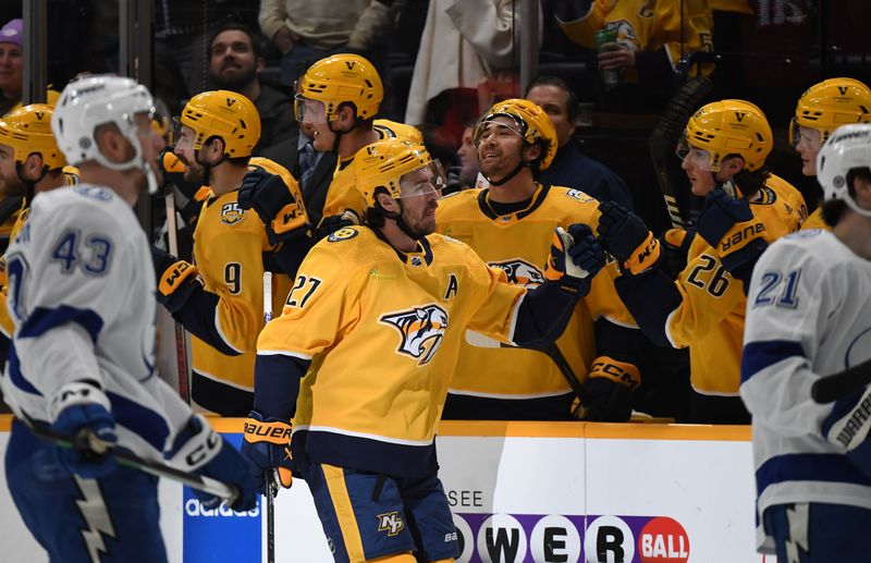 Dec 7, 2023; Nashville, Tennessee, USA; Nashville Predators defenseman Ryan McDonagh (27) is congratulated by teammates after a goal during the second period against the Tampa Bay Lightning at Bridgestone Arena. Mandatory Credit: Christopher Hanewinckel-USA TODAY Sports