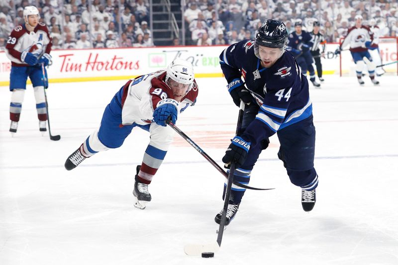 Apr 30, 2024; Winnipeg, Manitoba, CAN; Winnipeg Jets defenseman Josh Morrissey (44) is stick checked by Colorado Avalanche right wing Mikko Rantanen (96) in the first period in game five of the first round of the 2024 Stanley Cup Playoffs at Canada Life Centre. Mandatory Credit: James Carey Lauder-USA TODAY Sports
