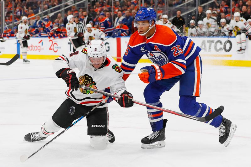 Oct 12, 2024; Edmonton, Alberta, CAN;Chicago Blackhawks forward Ryan Donato (8) and Edmonton Oilers defensemen Darnell Nurse (25) battles for position during the second period  at Rogers Place. Mandatory Credit: Perry Nelson-Imagn Images