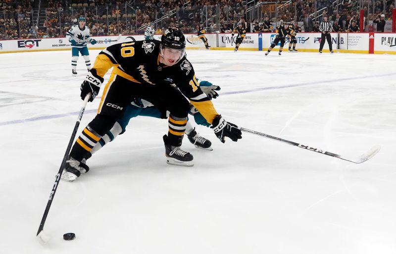 Mar 14, 2024; Pittsburgh, Pennsylvania, USA; Pittsburgh Penguins left wing Drew O'Connor (10) skates after the puck against the San Jose Sharks during the first period at PPG Paints Arena. Mandatory Credit: Charles LeClaire-USA TODAY Sports