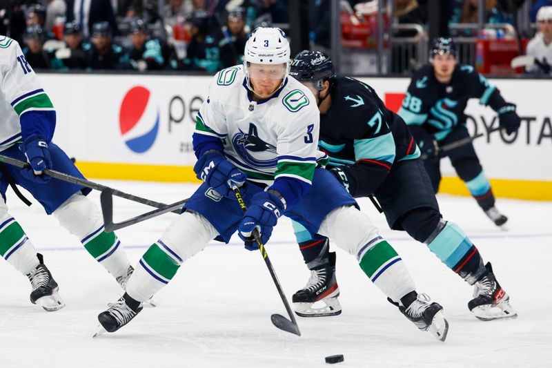 Oct 1, 2022; Seattle, Washington, USA; Vancouver Canucks defenseman Jack Rathbone (3) skates with the puck against the Seattle Kraken during the third period at Climate Pledge Arena. Mandatory Credit: Joe Nicholson-USA TODAY Sports