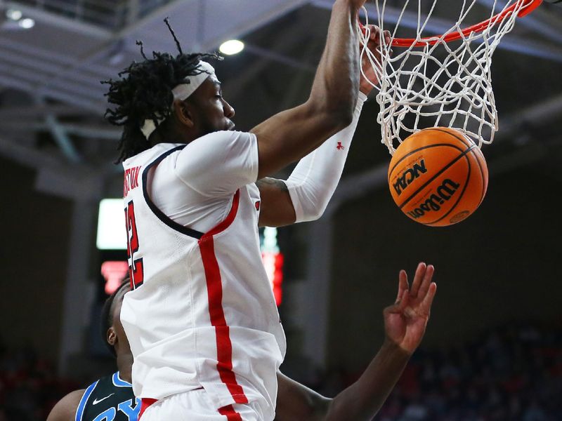 Jan 20, 2024; Lubbock, Texas, USA;  Texas Tech Red Raiders center Warren Washington (22) dunks against Brigham Young Cougars forward Fousseyni Traore (45) in the first half at United Supermarkets Arena. Mandatory Credit: Michael C. Johnson-USA TODAY Sports