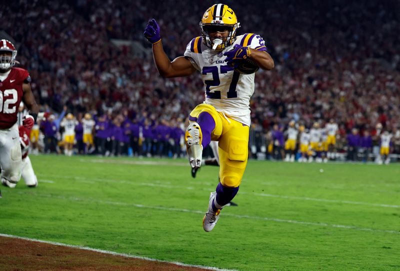 Nov 4, 2023; Tuscaloosa, Alabama, USA;  LSU Tigers running back Josh Williams (27) carries the ball in for a touchdown against the Alabama Crimson Tide during the second half at Bryant-Denny Stadium. Mandatory Credit: Butch Dill-USA TODAY Sports