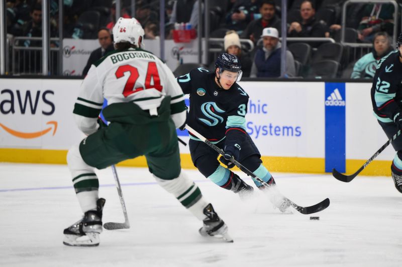 Dec 10, 2023; Seattle, Washington, USA; Seattle Kraken center Yanni Gourde (37) plays the puck during the second period against the Minnesota Wild at Climate Pledge Arena. Mandatory Credit: Steven Bisig-USA TODAY Sports