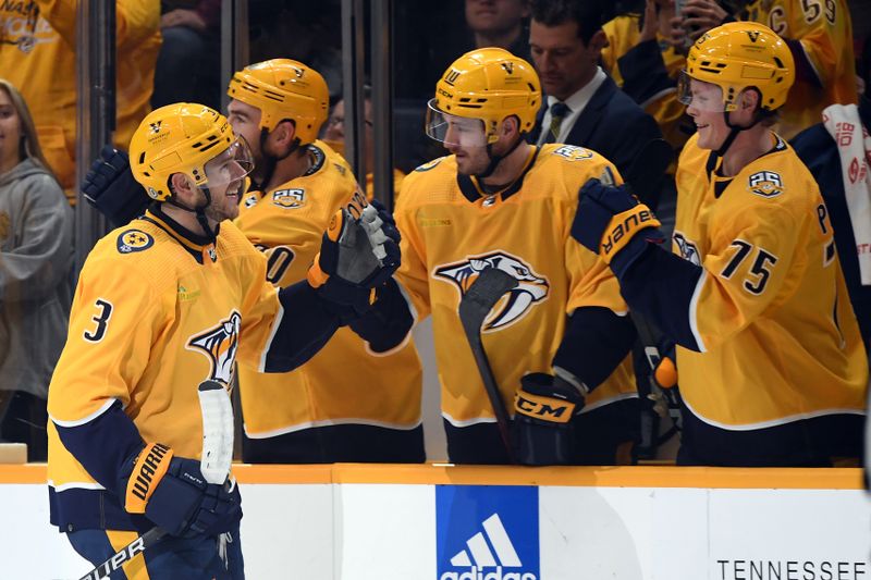 Dec 19, 2023; Nashville, Tennessee, USA; Nashville Predators defenseman Jeremy Lauzon (3) is congratulated by teammates after a goal during the second period against the Vancouver Canucks at Bridgestone Arena. Mandatory Credit: Christopher Hanewinckel-USA TODAY Sports