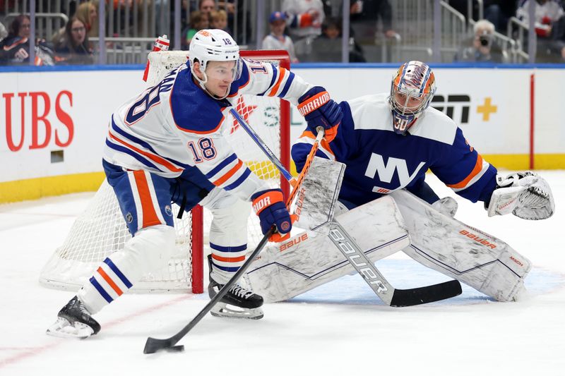 Dec 19, 2023; Elmont, New York, USA; Edmonton Oilers left wing Zach Hyman (18) plays the puck against New York Islanders goaltender Ilya Sorokin (30) during the third period at UBS Arena. Mandatory Credit: Brad Penner-USA TODAY Sports