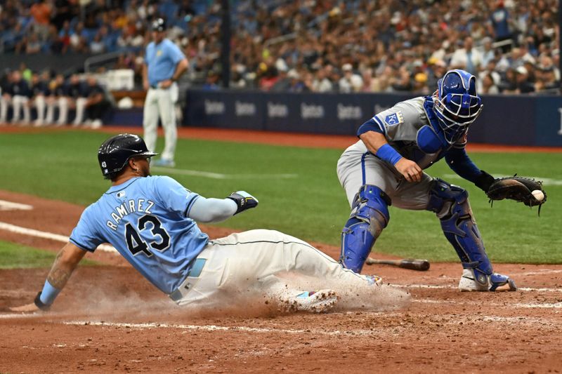 May 26, 2024; St. Petersburg, Florida, USA; Kansas City Royals catcher Freddy Fermin (34) tags home plate asTampa Bay Rays designated hitter Harold Ramirez (43) slides in the seventh inning at Tropicana Field. Mandatory Credit: Jonathan Dyer-USA TODAY Sports