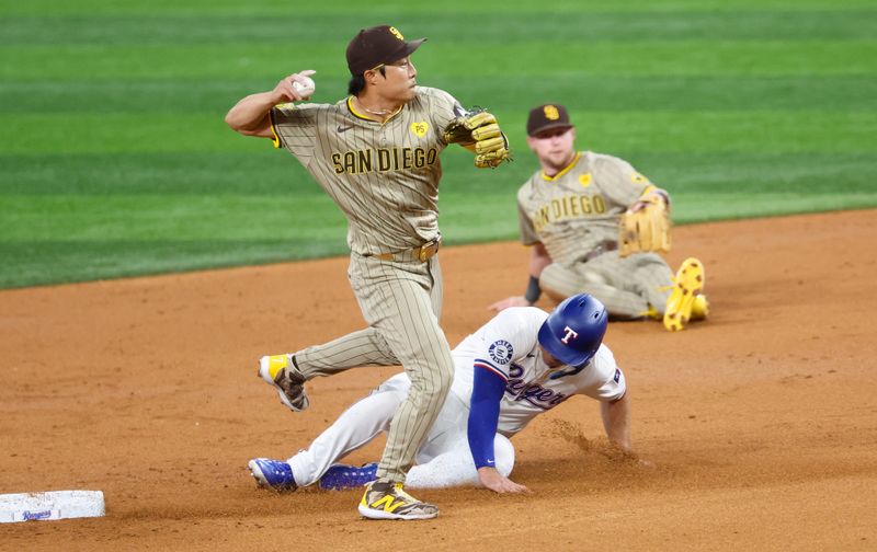 Jul 2, 2024; Arlington, Texas, USA;  San Diego Padres shortstop Ha-Seong Kim (7) completes a double play over Texas Rangers left fielder` Wyatt Langford (36) during the third inning at Globe Life Field. Mandatory Credit: Kevin Jairaj-USA TODAY Sports