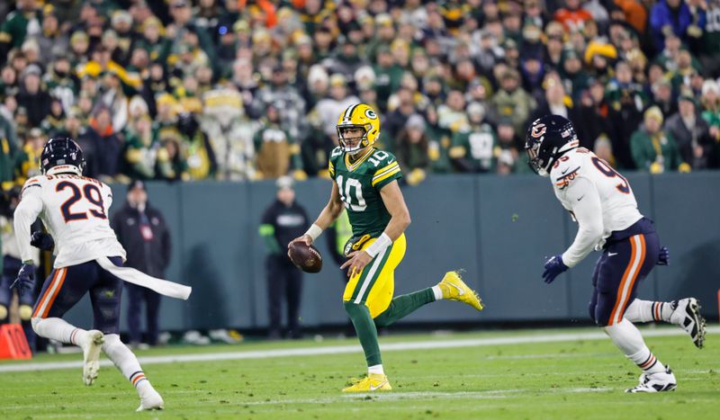 Green Bay Packers quarterback Jordan Love (10) runs during an NFL football game against the Chicago Bears Sunday, Jan. 7, 2024, in Green Bay, Wis. (AP Photo/Jeffrey Phelps