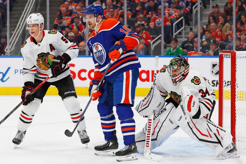 Oct 12, 2024; Edmonton, Alberta, CAN; Edmonton Oilers /forward Zach Hyman (18) tries to screen Chicago Blackhawks goaltender Petr Mrazek (34) during the third period at Rogers Place. Mandatory Credit: Perry Nelson-Imagn Images