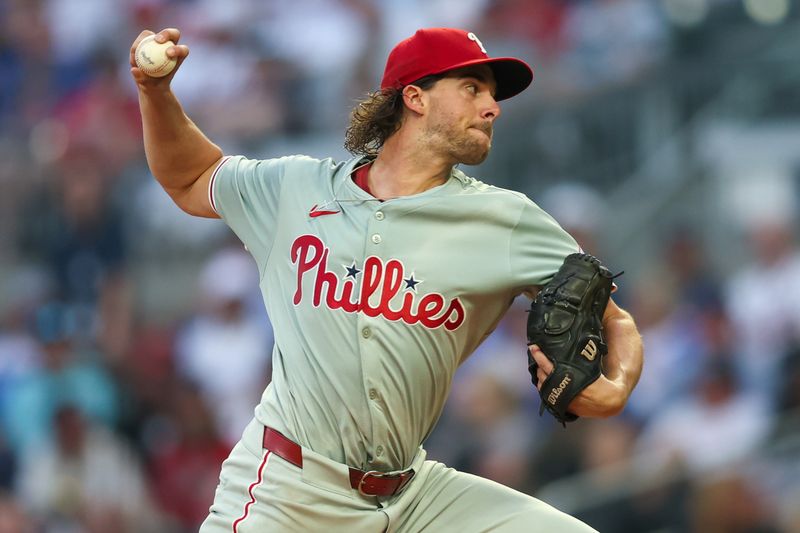 Aug 21, 2024; Atlanta, Georgia, USA; Philadelphia Phillies starting pitcher Aaron Nola (27) throws against the Atlanta Braves in the third inning at Truist Park. Mandatory Credit: Brett Davis-USA TODAY Sports