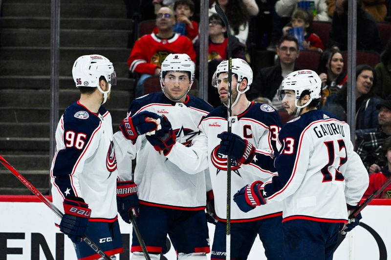 Mar 2, 2024; Chicago, Illinois, USA;  Columbus Blue Jackets center Boone Jenner (38), second from right, celebrates his goal against the Chicago Blackhawks with teammates during the first period at the  United Center. Mandatory Credit: Matt Marton-USA TODAY Sports