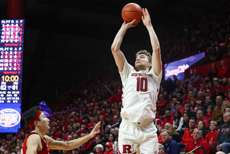 Feb 14, 2023; Piscataway, New Jersey, USA; Rutgers Scarlet Knights guard Cam Spencer (10) shoots the ball against Nebraska Cornhuskers guard Keisei Tominaga (30) during the second half at Jersey Mike's Arena. Mandatory Credit: Vincent Carchietta-USA TODAY Sports