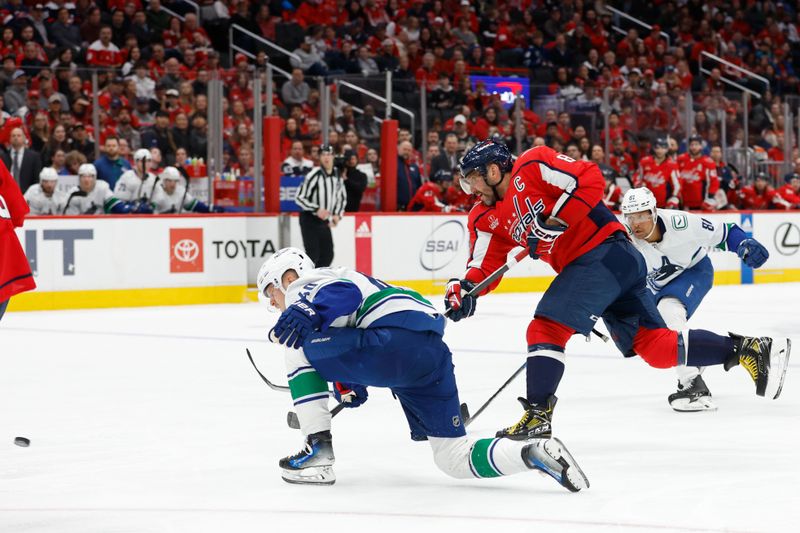 Feb 11, 2024; Washington, District of Columbia, USA; Washington Capitals left wing Alex Ovechkin (8) shoots the puck as Vancouver Canucks center Elias Pettersson (40) defends in the third period at Capital One Arena. Mandatory Credit: Geoff Burke-USA TODAY Sports