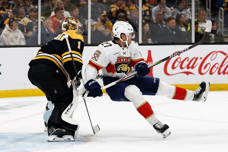 Oct 14, 2024; Boston, Massachusetts, USA; Boston Bruins goaltender Jeremy Swayman (1) spills Florida Panthers center Eetu Luostarinen (27) who was screaning him in front during the first period at TD Garden. Mandatory Credit: Winslow Townson-Imagn Images