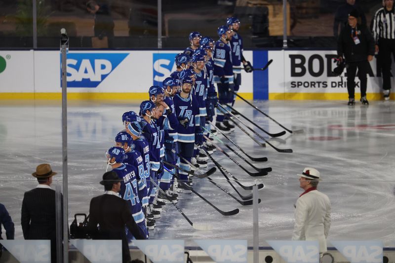 Feb 1, 2026; Tampa Bay, Florida, USA; The Tampa Bay Lightning stand on the ice during the national anthem in the 2026 Stadium Series ice hockey game against the Boston Bruins at Raymond James Stadium. Mandatory Credit: Nathan Ray Seebeck-Imagn Images