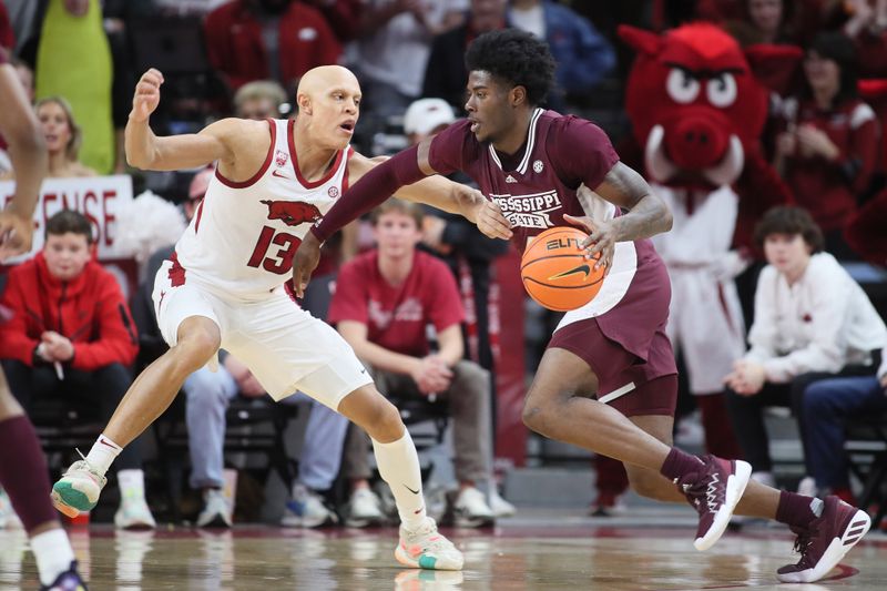 Feb 11, 2023; Fayetteville, Arkansas, USA; Mississippi State Bulldogs guard Cameron Matthews (4) drives against Arkansas Razorbacks guard Jordan Walsh (13) during the first half at Bud Walton Arena. Bulldogs won 70-64. Mandatory Credit: Nelson Chenault-USA TODAY Sports