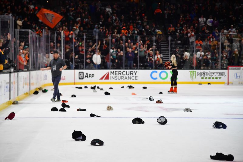 Nov 1, 2023; Anaheim, California, USA; Spectators throw hats celebrating the hat trick goal scored by Anaheim Ducks right wing Troy Terry (19) against the Arizona Coyotes at Honda Center. Mandatory Credit: Gary A. Vasquez-USA TODAY Sports