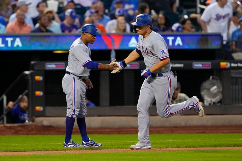 Aug 30, 2023; New York City, New York, USA;  Texas Rangers third base coach Tony Beasley (27) congratulates Texas Rangers shortstop Corey Seager (5) for hitting a home rum as he rounds the bases during the fourth inning at Citi Field. Mandatory Credit: Gregory Fisher-USA TODAY Sports