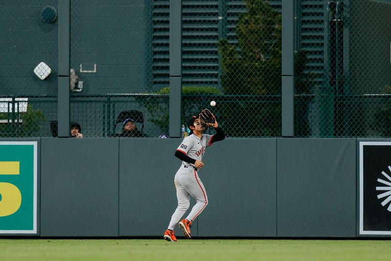 May 7, 2024; Denver, Colorado, USA; San Francisco Giants center fielder Jung Hoo Lee (51) makes a catch in the fifth inning against the Colorado Rockies at Coors Field. Mandatory Credit: Isaiah J. Downing-USA TODAY Sports